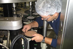 K2 Engineering's Scott Hess installs bottle plates on the output side of the ELAU servo motor/drives.