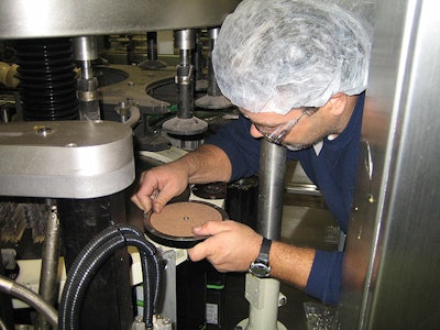 K2 Engineering's Scott Hess installs bottle plates on the output side of the ELAU servo motor/drives.