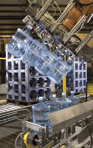 The end-of-arm tooling uses three vacuum cups per bottle to pick empty bottles from a rack; in this picking mode, the mechanical
