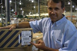 Deluxe's director of engineering Jeff Nelson points to a small naked tag that RFID-enables a case of DVDs. In another app