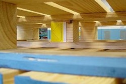 The yellow RFID tag can be seen folded and stapled to the pallet's center post.