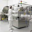 Standing in front of the eight-head piston filler, a PharmaFab employee monitors production on the company's new liquid pharmac