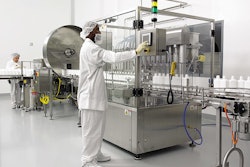 Standing in front of the eight-head piston filler, a PharmaFab employee monitors production on the company's new liquid pharmac