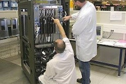 Technicians assembling a server.
