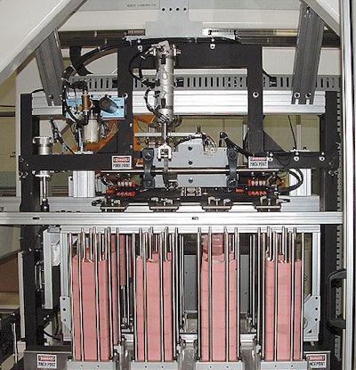 Supply magazine provides labels to six-axis robot.