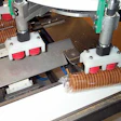 Slugs of Ginger Nuts in clear, cold-seal film move from rotary wheel transfer.
