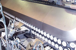 Shown at left is P&G's Gross Gerau tube filler during a break. A robot inserts tubes 20 at a time into pockets in the portion of