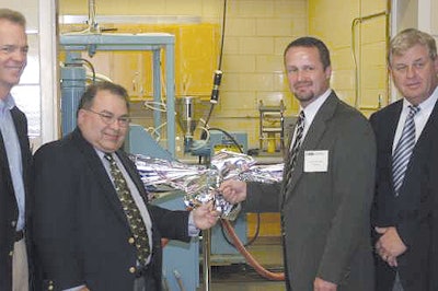 Robert M. Kimmel (left) and W. Scott Whiteside cut the ribbon at the opening of Clemson's Center for Flexible Packaging.