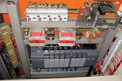 Above, a new SLC now sits at the bottom of the controls cabinet for Truitt Bros.' tray-packer/shrink-wrapper system, replacing a