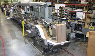 Operators use the touchscreen panels to control the paperboard beverage-carrier erector.