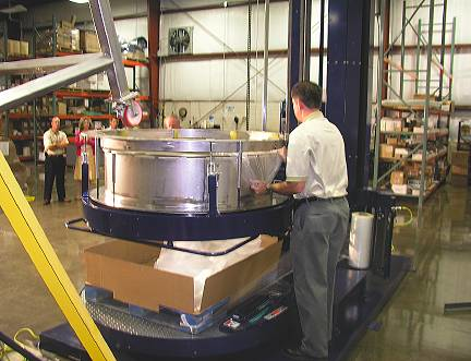 The first step in the K-one process is to place a corrugated tray on a pallet and hang a plastic bag from the K-one collar.