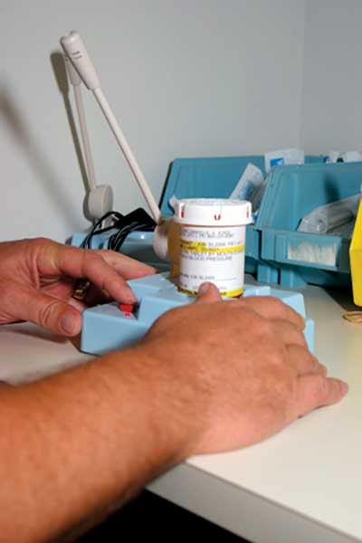 A patient presses and holds the button to hear those details on the 'talking' bottle.