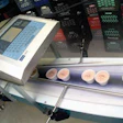 Ink-jet printers apply codes to ice cream cups as they pass by on their way to a metal detector and on to hand packing into ship