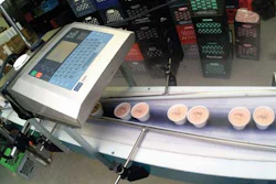 Ink-jet printers apply codes to ice cream cups as they pass by on their way to a metal detector and on to hand packing into ship