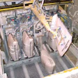 A robotic bag loader moves a new valve bag into one of the four filling stations on the filler, which has been upgraded with el