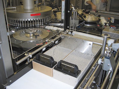 Above photo shows one of two infeed stations, including the feed screw, used to feed vials into the labeler.