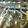 In this birds-eye view at Peak Foods, bowls are conveyed from parallel shrink banders at the bottom to the accumulation table at
