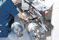 Line technician Omar Micheo loads a fresh roll of foil-based film to one of the six f/f/s machines that wrap Nephron's vials.