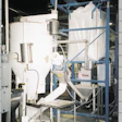 Snyder of Berlin's bulk bag unloader discharges 2,000 lb of cornmeal into a hopper before a 4 '-diameter flexible screw conveyor