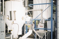 Snyder of Berlin's bulk bag unloader discharges 2,000 lb of cornmeal into a hopper before a 4 '-diameter flexible screw conveyor
