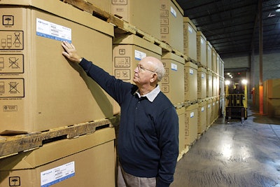 C&D Warehouse president Gene Cravey checks the sidewalls of some of Basell's boxes with new moisture barrier.