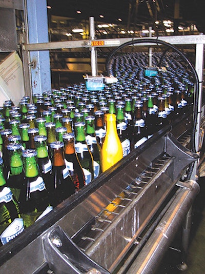The yellow 'Smart Bottle' is conveyed on bottling lines to measure vibration and impact from the bottle's perspective.