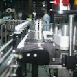 Bottles index single file from front to back through a timing screw (left) before a label is wiped on.
