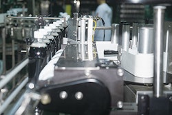 Bottles index single file from front to back through a timing screw (left) before a label is wiped on.