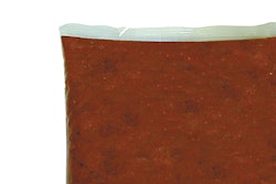 Paradise Tomato Kitchens has added an easy-opening tear notch (top) to its foodservice pouches.