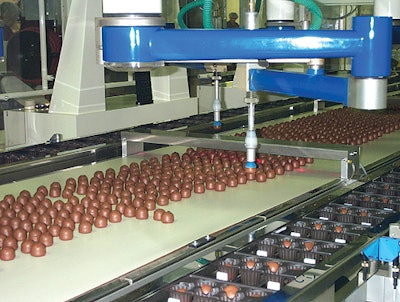 Operating using 4 axes, each robot picks a cordial from the conveyor and places it into the tray at an average rate of 1.5 cordi