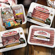 New packaging materials at Clougherty Packing include barrier plastic trays and barrier lidding material heat sealed to tray fla