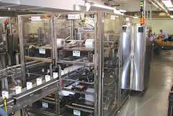 Cartoned bottles march in single file into the entrance of the shrink wrapper at rates to 100/min (left) and emerge neatly bundl
