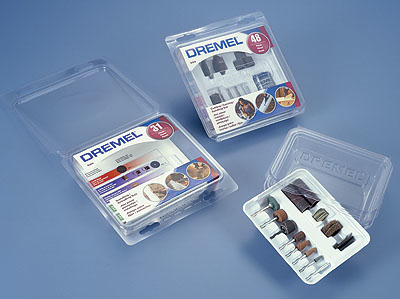 Shown at left are all four pieces to the new package: precision white tray and inside clamshell (right), and exterior clamshell