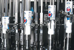 Sealed with foil lids, bottles emerge from the aseptic filling system in two parallel lanes (left). Colorful shrink-sleeve label