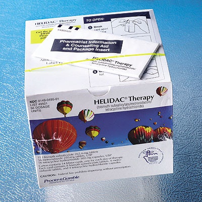 The carton containing Helidac therapy holds 14 individual blister cards (shown empty at top). Each blister has four daily dosage