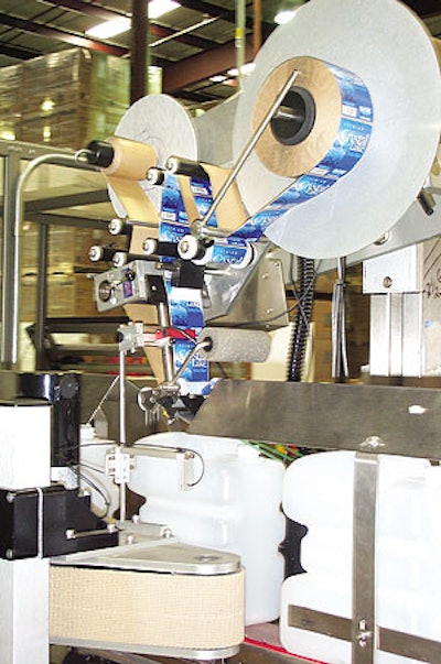 This labeler's sliding head makes it possible to apply labels on a bottle's top or side panel.