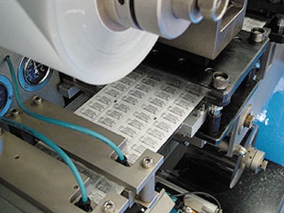 At this blister sealer, printed lid stock with a truncated bar code is applied and heat sealed to a blister containing medicatio