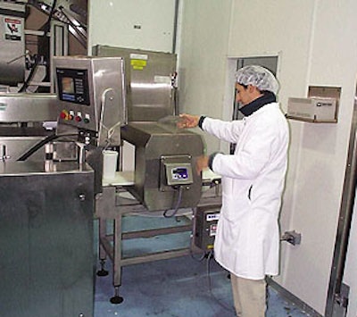 An operator calibrates a metal detector based on salad type (above), identifying the product's conductive properties and therefo