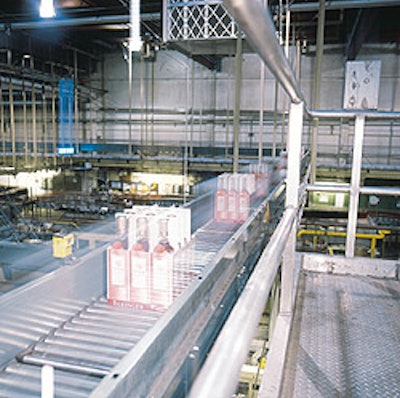 A new conveyor (inset) moves cases of wine to a new palletizer and wrapper installed October 2001.