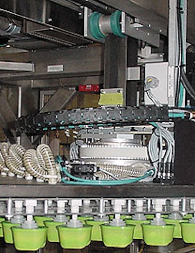 This pick-and-place robot uses vacuum pick-up cups to transfer filled cups from the filling/lidding system to the case packer.