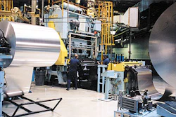 Rexam makes beverage cans (left) from huge coils of aluminum (above). The aluminum order is automatically processed for payment