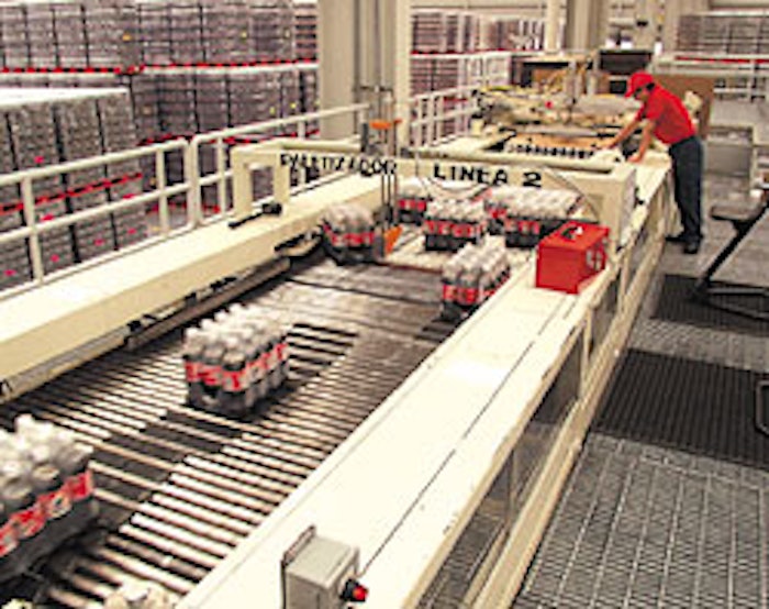 On the infeed to the palletizer (left), the machine vision camera points downward toward the bundled packs (opposite right). The