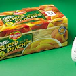 The upstream unit of the two-labeler setup is applying the label (above) to the top of the multipack of canned fruit or vegetabl