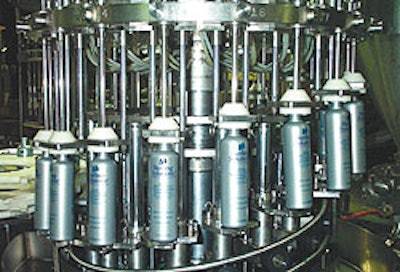 Backside view shows the cam-operated platforms under each bottle that raise and lower during the filling cycle to minimize splas