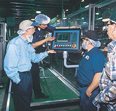 Poland Spring personnel and Christian Schlichtenbrede (in back) of Kisters Kayat observe a control panel for a multipacker used