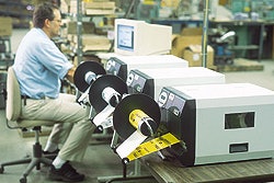 Lou Raucci, manager of packaging at Amertac, loads a print order behind the three new label printers.