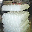 Lengthy line starts with robotic depalletizing where the bagged jugs are picked and placed onto an infeed table for automatic de