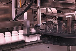 A special indexing feature in the desiccant feeder ensures that one desiccant canister is inserted into each passing bottle, inc