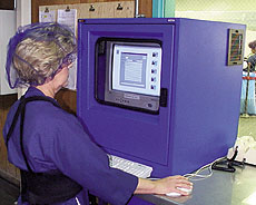 Blue Diamond Growers' line operator Sharon Anderson (above) uses a mouse and keypad to load a message into one of five networked