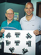 Dutch (left) and Don LaJeunesse hold a skin-packed pad of stainless-steel components in front of their company's new skin packag